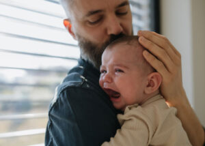 Father consoling crying baby