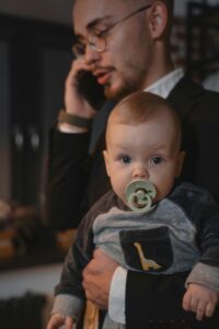 Dad on phone w baby pic